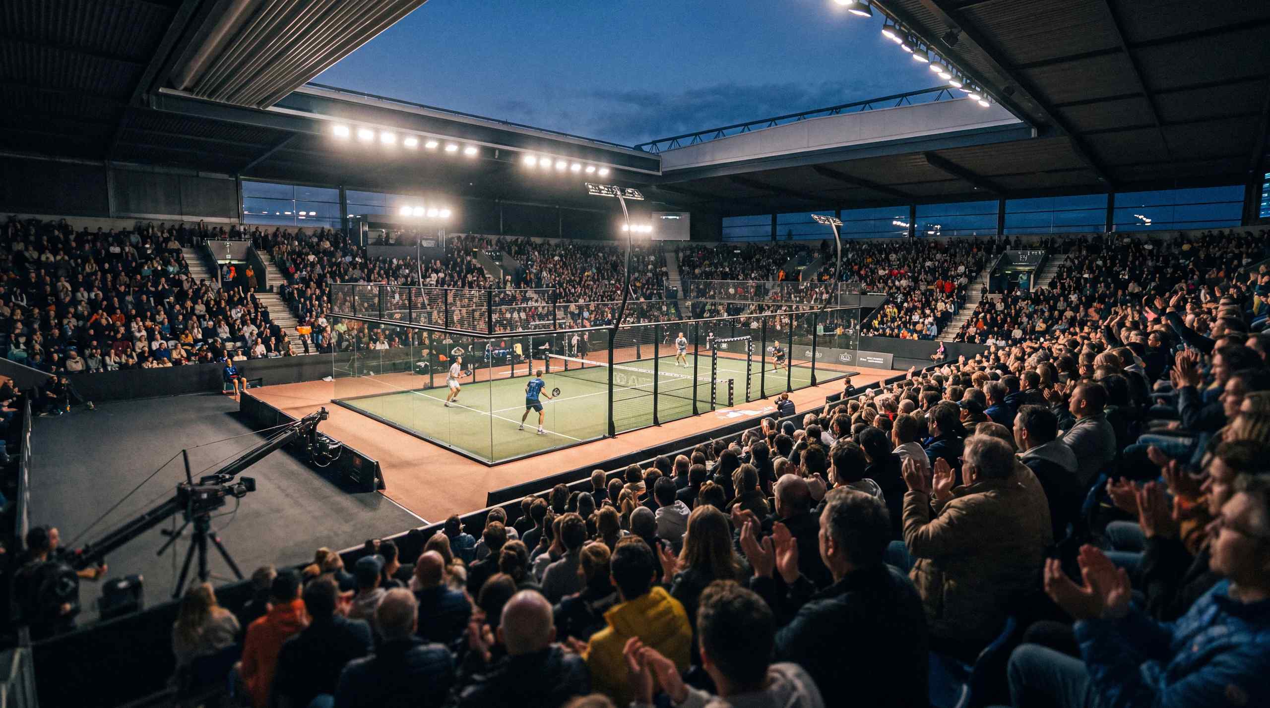 Padel match in a crowded stadium.